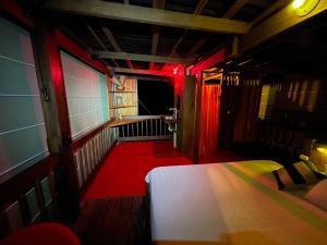 努基La Kuka Hotel - Nuquí的小房间,设有床铺和红色灯光