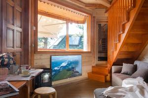 安泰伊-萨伊恩特-安德尔埃DalaiLama Village的客厅设有大窗户和电视。