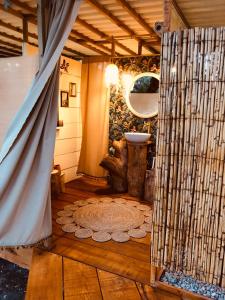 奇克拉纳－德拉弗龙特拉Glamping - La Casa del Piano的浴室铺有木地板,设有一扇门。
