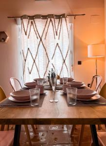 塞拉内华达Apartamentos Vista Sierra Nevada的一张木桌,上面放有盘子和酒杯