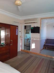 卢克索Villa Nile House Luxor的客房设有床、电视和沙发。