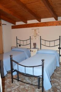 贡内萨Giardino degli Ulivi的配有木天花板的客房设有两张床。