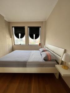 伊斯坦布尔Your home in istanbul的一间卧室设有一张大床和两个窗户。
