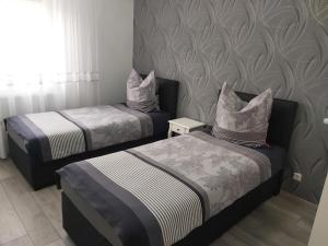 莱茵豪森EBS Paradies的配有2张单人床的带墙壁客房