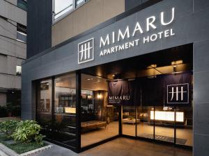 东京MIMARU TOKYO GINZA EAST的大楼一侧的mhmarma公寓标志