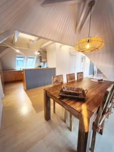 汉堡LOFT-Panoramablick-HAFEN & ELBE!的一间带木桌的用餐室和一间厨房