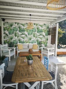 格拉斯托斯La Stella Stay的天井配有桌椅,墙上挂有植物