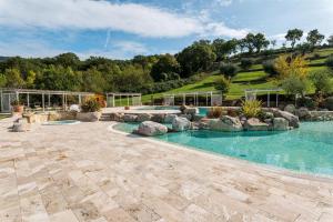 RoccalbegnaCaciaia的一座位于庭院的带岩石的室外游泳池