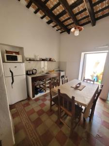 圣弗朗西斯科德尔蒙特蒙奥罗Casa Sarmiento的厨房配有桌子和白色冰箱。