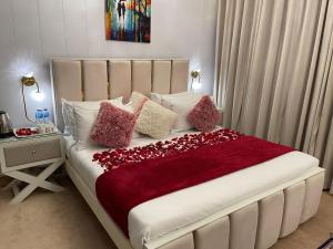 伊斯兰堡The Life Style Lodges opp Centaurus Mall的一张带红色毯子和枕头的床