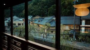 丰冈市Kobayashiya -Kinosaki Onsen-的享有带房屋的城镇的窗户景致。