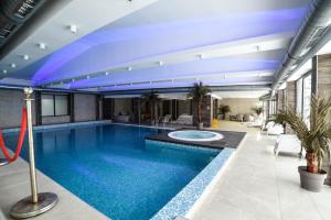 科帕奥尼克Apartman La Foresta Kopaonik的一座拥有蓝色天花板的大型游泳池