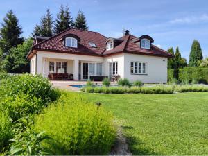 Planá nad LužnicíVila Plana nad Luznici的一座大型白色房屋,设有红色屋顶