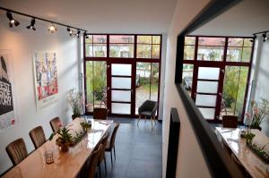 Loft industriel dans une ancienne grange的用餐室配有桌椅和大窗户