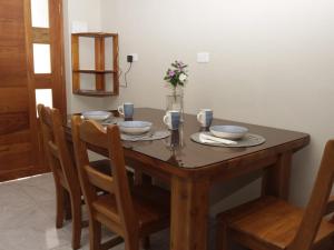 阿约拉港Casa Itabaca II的一张木桌,上面放有盘子和碗