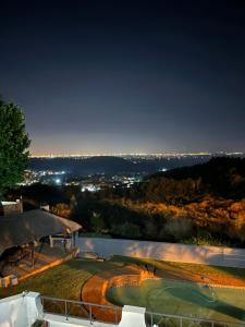 约翰内斯堡Glenvista Home with a View的享有高尔夫球场的夜间景色