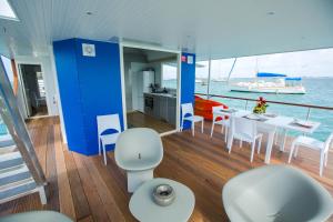 豪特尔Aqualodge, Les Saintes, Terre de Haut的船上配有桌椅的房间
