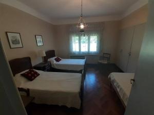 拉法尔达Amplia Casona de Estilo en La Falda的酒店客房设有两张床和窗户。