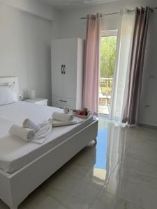 卡萨米尔Villa Angelina Ksamil的一间卧室设有一张床和一个大窗户