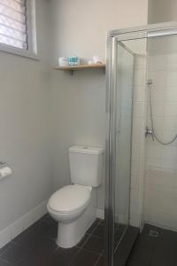 达尔文加文纳酒店的一间带卫生间和玻璃淋浴间的浴室