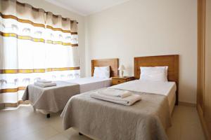 卡巴纳斯·德·塔维拉Apartamento Duja的酒店客房设有两张床和窗户。