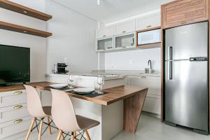 弗洛里亚诺波利斯Apartamentos completos ao lado da UFSC - NAVONA的厨房配有不锈钢冰箱和白色橱柜