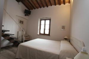 蓬萨科Agriturismo San Martino的卧室配有白色的床和窗户。
