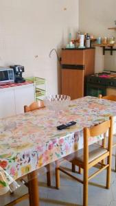 兰佩杜萨Appartamento con giardino的厨房里一张桌子上放着鲜花的桌布