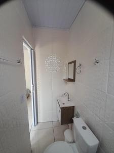大普拉亚Pousada do Forte的白色的浴室设有卫生间和水槽。