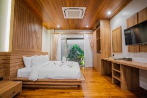 普吉镇Malabar Pool Villa Phuket的卧室配有白色的床和电视。