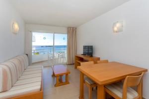 伊维萨镇大海与沙滩公寓的带沙发和桌子的客厅以及用餐室