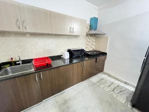 海得拉巴BedChambers Serviced Apartment, Jubilee Hills的厨房配有水槽和微波炉