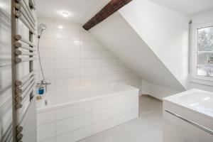 圣加仑EH Apartments Jupiter的白色的浴室设有浴缸和水槽。