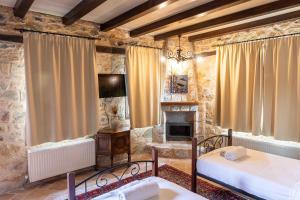 弗洛里纳Lithea mountain resort and spa的一间卧室设有两张床和一个壁炉