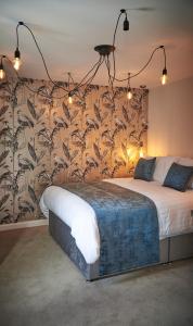 利物浦Home @ 2 Tancred Road的一间卧室配有一张带花卉壁纸的大床