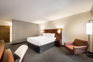 圣何塞圣何塞机场万怡酒店的配有一张床和一把椅子的酒店客房