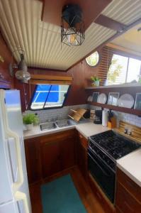 SavannaThe Lily Pad Boatel Houseboat的小厨房配有炉灶和冰箱