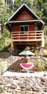 圣维森特Tentstar Eco Resort的小屋前的桌子和雨伞