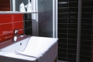 LA FERME D'ANDRE的浴室设有白色水槽和红色的墙壁