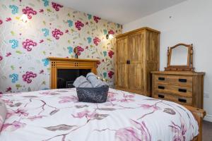 DistingtonComfy Cumbrian Stay的一间卧室配有一张华丽壁纸床