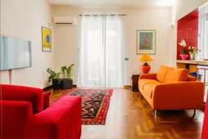 卡塔尼亚AmoCatania Apartment的客厅配有2张橙色沙发和地毯。