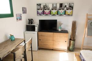 科蒂略Casa Nami的客厅配有桌子、微波炉和电视