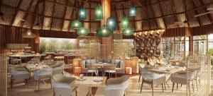 AkaouaneInterContinental Lifou Wadra Bay Resort的餐厅的 ⁇ 染,配有桌椅