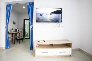 芭东海滩Grand View Premium的客厅的墙上配有电视