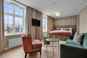 奥斯陆贾贝尔胡斯克拉丽奥连锁酒店的酒店客房配有床、沙发和桌子。