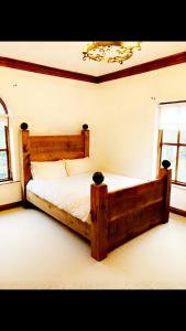 阿马Ridge Wood House的一间带木床的卧室,位于带窗户的客房内