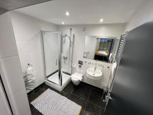兰卡斯特Sun Street Aparthotel的带淋浴、卫生间和盥洗盆的浴室