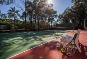 伊瓜苏Sanma Hotel的网球场上的网球拍和球