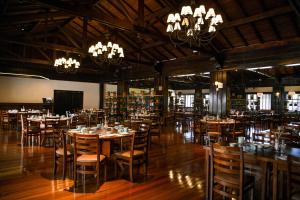 伊瓜苏Sanma Hotel的用餐室配有桌椅和吊灯。