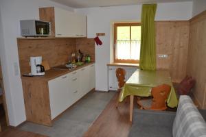 多比亚科Gostnerhof的带桌子的厨房和带台面的小厨房